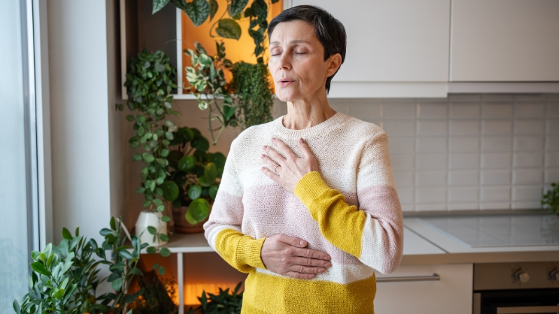 Woman practicing slow breathing to calm anxiety spikes