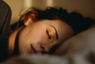 Woman sleeping peacefully at night with a stable sleep schedule
